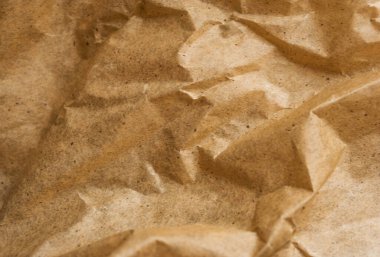 Kahverengi ambalaj kağıdı arka planı, sarı kırışık eski kağıt, kağıt yüzeyinde kırışıklıklar.