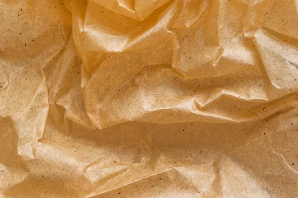 Kahverengi ambalaj kağıdı arka planı, sarı kırışık eski kağıt, kağıt yüzeyinde kırışıklıklar.