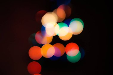 Soyut renkli, odaklanmış dairesel fakül. Bokeh bulanık renk ışığı arka planı kullanabilir. Yeni yıl Bokeh feshi
