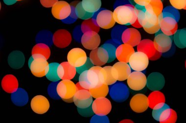 Soyut renkli, odaklanmış dairesel fakül. Bokeh bulanık renk ışığı arka planı kullanabilir. Yeni yıl Bokeh feshi