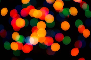 Soyut renkli, odaklanmış dairesel fakül. Bokeh bulanık renk ışığı arka planı kullanabilir. Yeni yıl Bokeh feshi