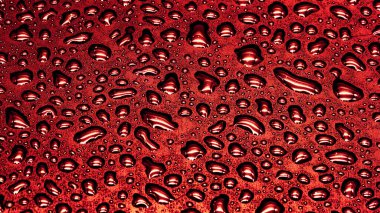 Kırmızı zemin üzerinde su damlaları, doku yakın çekim