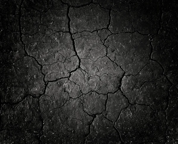 Siyah çatlamış zemin dokusu arka planı