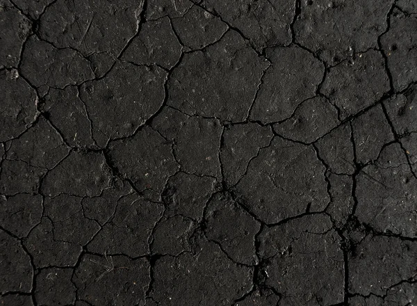 Siyah kurumuş ve çatlamış toprak zemin zemin, gri çatlak zemin, gri çatlak yüzey, koyu çatlak doku, tasarımcılar için.