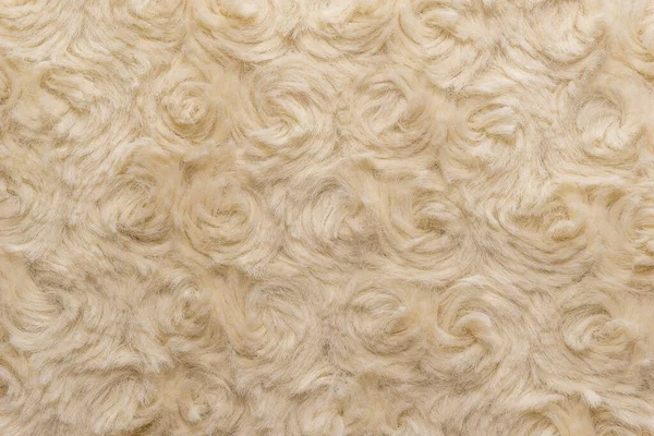 Beige natural wool with twists texture background. Cotton wool, white fleece carpet. White fur rug with pattern