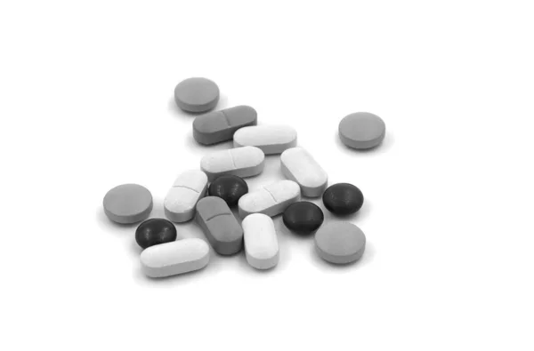 Black and white tablets (pills) on a white background