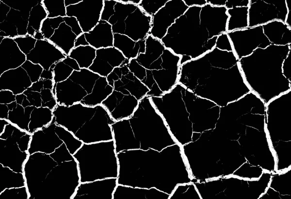 Black dried and cracked ground earth background. Closeup of dry fissure dark ground. crack on surface texture. erosion