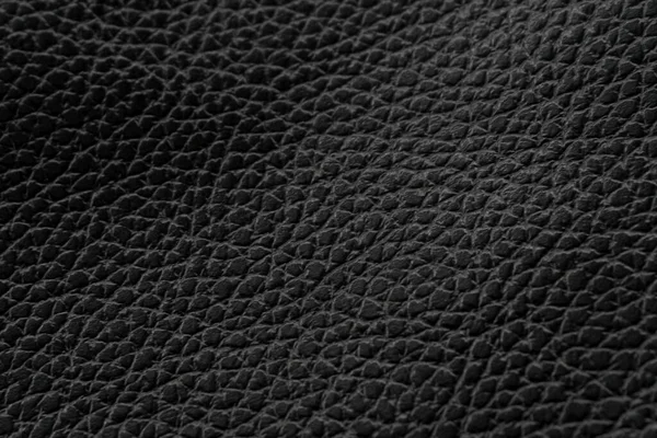 ブラックナチュラルレザーテクスチャマクロ パターンを持つ暗い材料 壁紙の背景 — ストック写真