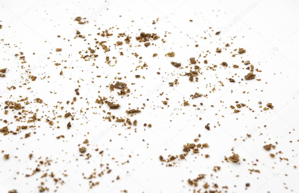 Bread crumbs on a white background. Scattered remnants of bread