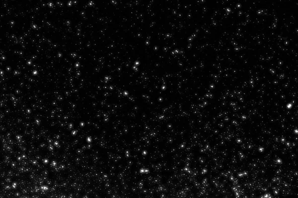 Siyah arkaplanda kaotik beyaz bokeh, ışık lekeleri dokusu, soyut bulanıklık, düşen kar, yıldızlı gökyüzü