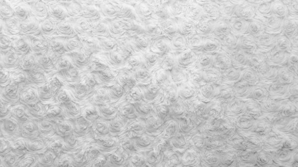 Белая натуральная шерсть с крученым текстурным фоном. Хлопчатобумажная шерсть, ковер из белого шерсти. Меховой ковер с узором