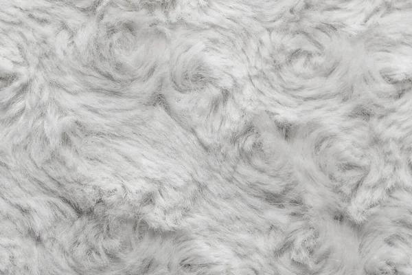 White natural wool with twists texture background. Cotton wool, white fleece carpet. Fur rug with pattern