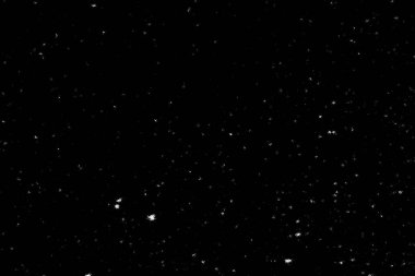 Siyah arka planda beyaz lekeler ve izler var. Beyaz bulanıklık ve dalgalanmalar. Kar yağışı, soyutlama