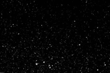 Siyah arka planda beyaz lekeler ve izler var. Beyaz bulanıklık ve dalgalanmalar. Kar yağışı, soyutlama