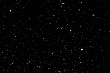 Siyah arka planda beyaz lekeler ve izler var. Beyaz bulanıklık ve dalgalanmalar. Kar yağışı, soyutlama