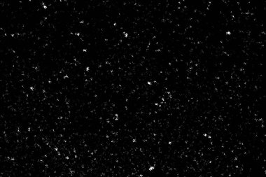 Siyah arka planda beyaz lekeler ve izler var. Beyaz bulanıklık ve dalgalanmalar. Kar yağışı, soyutlama