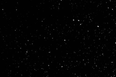 Siyah arka planda beyaz lekeler ve izler var. Beyaz bulanıklık ve dalgalanmalar. Kar yağışı, soyutlama