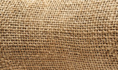 Çuval bezi dokusu yakın plan. Bağlanmış küçük ipler.