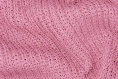 Pembe örülmüş süveterin dokusu, yakın plan, kırmızı örgü yün.