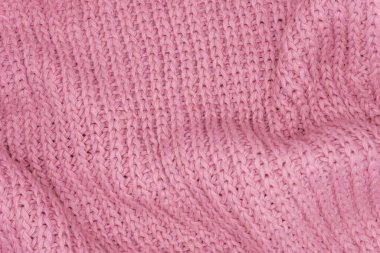 Pembe örülmüş süveterin dokusu, yakın plan, kırmızı örgü yün.