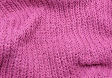 Pembe örülmüş süveterin dokusu, yakın plan, kırmızı örgü yün.