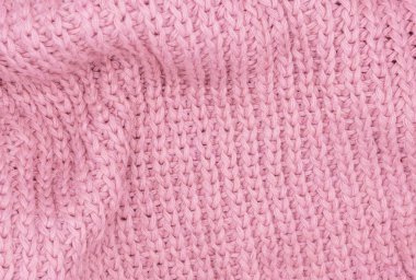 Pembe örülmüş süveterin dokusu, yakın plan, kırmızı örgü yün.