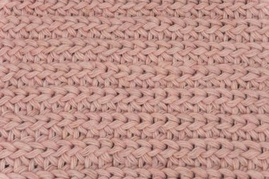Pembe örülmüş süveterin dokusu, yakın plan, kırmızı örgü yün.