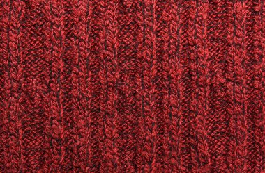 Kırmızı örülmüş süveterin dokusu yakın plan. Örgü yün malzeme.