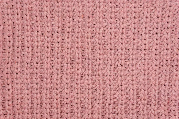 Pembe örülmüş süveterin dokusu yakından, kırmızı örülmüş yün.