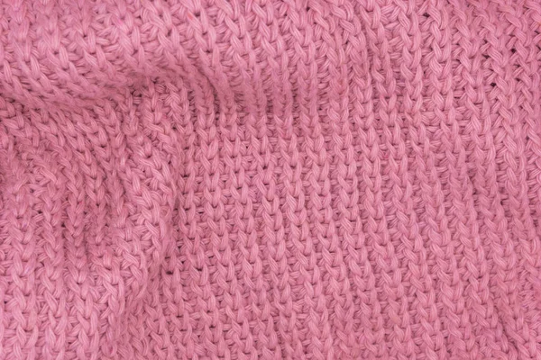 Pembe örülmüş süveterin dokusu, yakın plan, kırmızı örgü yün.