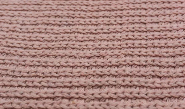 Pembe örülmüş süveterin dokusu, yakın plan, kırmızı örgü yün.