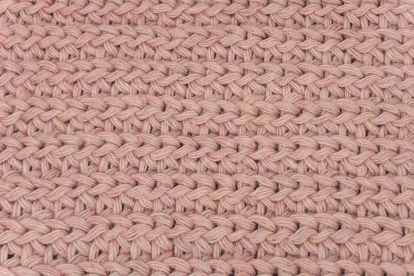 Pembe örülmüş süveterin dokusu, yakın plan, kırmızı örgü yün.