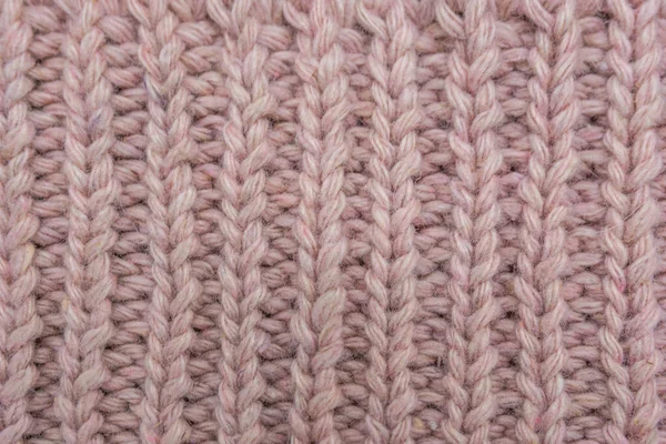 Pembe örülmüş süveterin dokusu, yakın plan, kırmızı örgü yün.