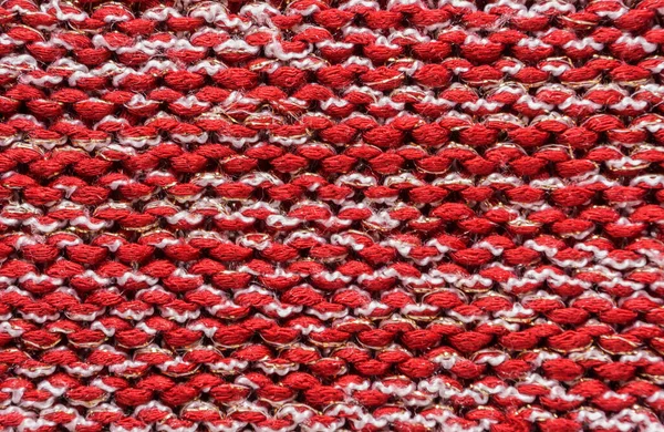 Texture of a red  and white knitted sweater closeup. knitted wool material