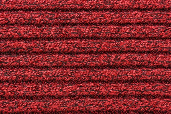 Texture of a red knitted sweater closeup. knitted wool material