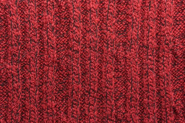 Texture of a red knitted sweater closeup. knitted wool material
