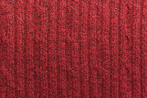 Texture of a red knitted sweater closeup. knitted wool material