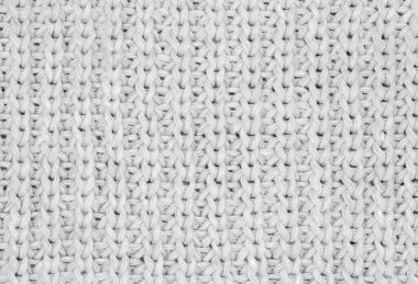 Örülmüş süveterin dokusu, yakın çekim, beyaz örülmüş kur.