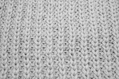 Örülmüş süveterin dokusu, beyaz örülmüş yün.