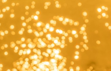 Sarı bokeh arkaplan dokusu. Altın bulanık parlak parlak ışık dokusu