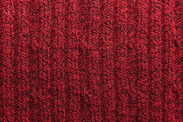 Kırmızı örülmüş süveterin dokusu yakın plan. Örgü yün malzeme.