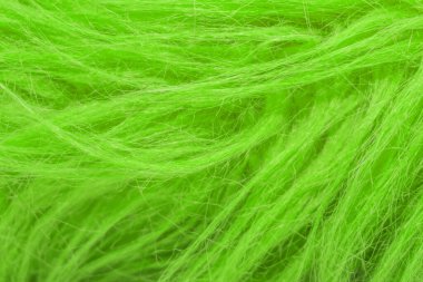 Yeşil kabarık yün dokusu, hayvan yünü arka planı, boyanmış kürk dokusu yakın plan.