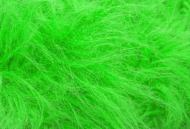 Yeşil kabarık yün dokusu, hayvan yünü arka planı, boyanmış kürk dokusu yakın plan.