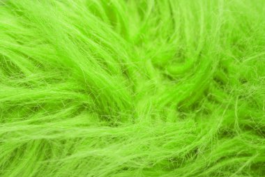 Yeşil kabarık yün dokusu, hayvan yünü arka planı, boyanmış kürk dokusu yakın plan.