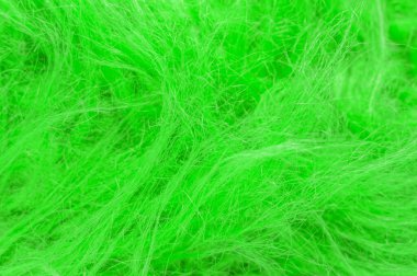 Yeşil kabarık yün dokusu, hayvan yünü arka planı, boyanmış kürk dokusu yakın plan.