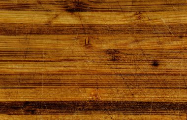 Arka planda çizikler olan eski ahşap tahta, kahverengi kesim tahtası, ahşap doku, hasarlı ahşap yüzey.