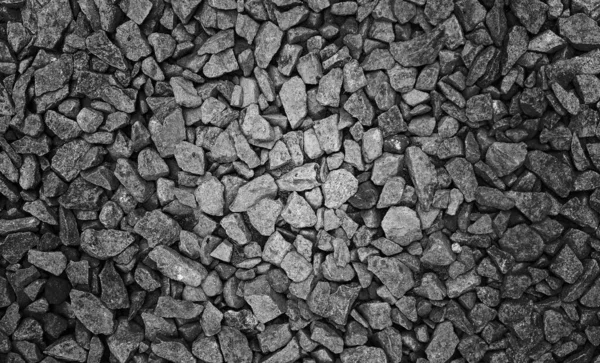 Gri çakıl taşları hafif benekli arka plan desenli.