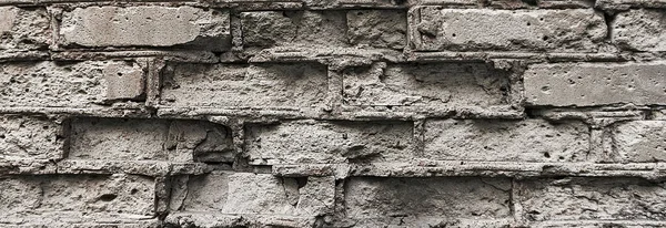 fragment of an old broken brick wall background