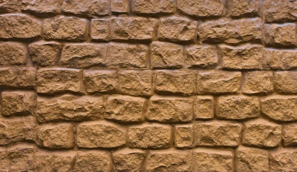 Orange wall from stone blocks texture background