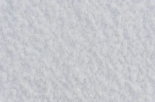 White pure snow texture, background of fresh snow texture in blue tone, rough snowy surface